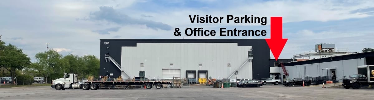 Front of the warehouse showing the visitor parking and office entrance