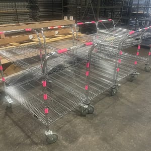 Four wire carts lined up next to each other.