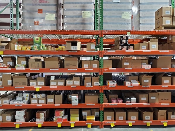 Carton flow rack filled with boxes in a warehouse.