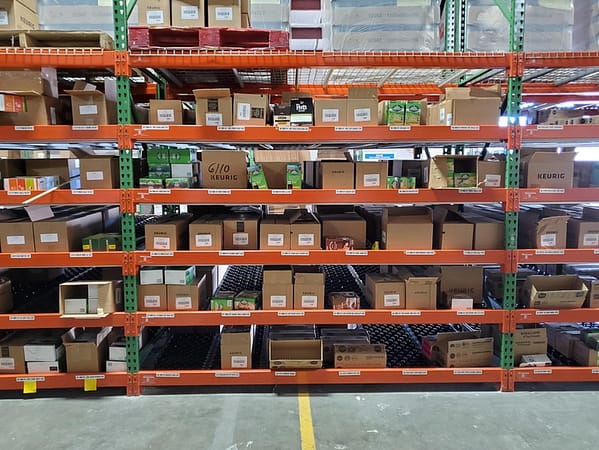 Carton flow rack filled with boxes in a warehouse.