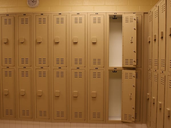 Two-tier HDPE lockers in a locker room, with a tan finish.