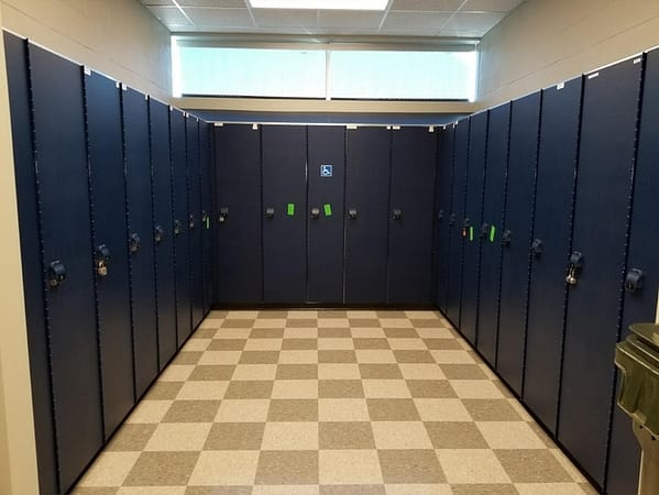 Single-tier HDPE lockers in a locker room, with a blue finish.