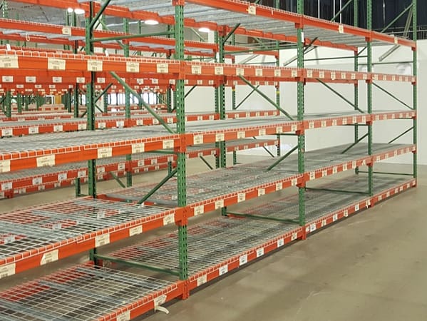 Pallet rack with wire deck in a warehouse.