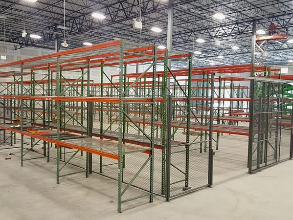 Pallet rack inside and outside a wire partition cage.