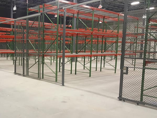 Pallet rack surrounded by a wire partition cage.