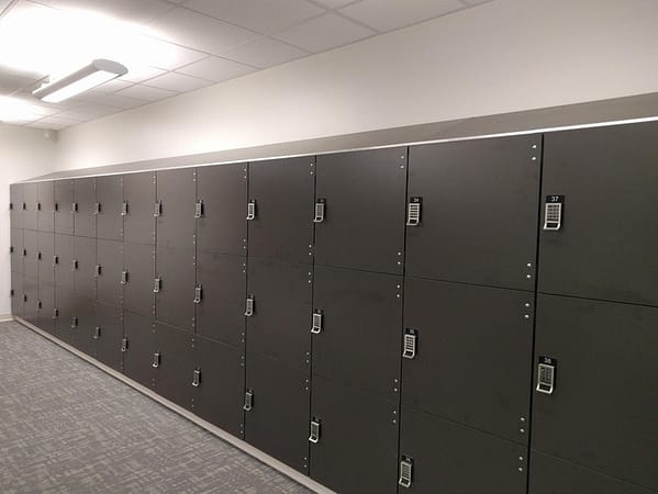Three-tier phenolic lockers in a room, with a black finish.