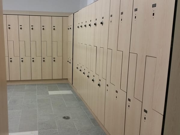 Phenolic z-lockers in a locker room, with a wood style finish.