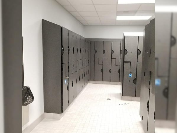 Plastic laminate z-lockers in a locker room, with a gray finish.