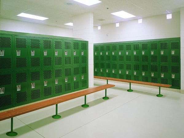 All Welded Ventilated Athletic Lockers in a locker room with a green finish, by Republic Storage Products.