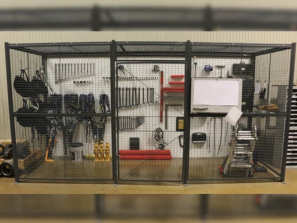 Wire partition cage functioning as a tool cage filled with equipment, by Wirecrafters.