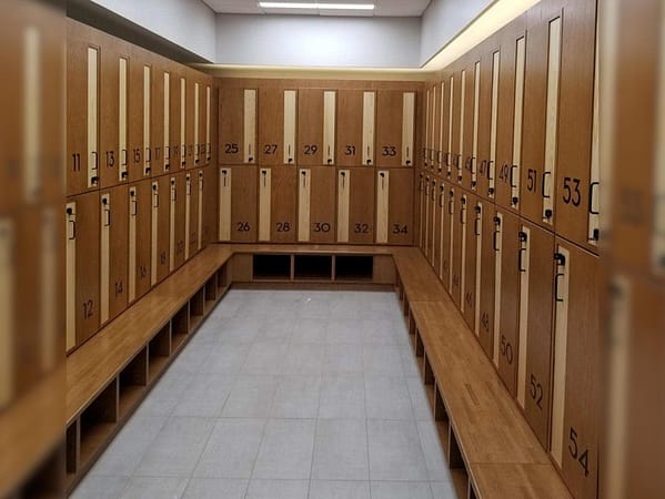 Two-tier wood lockers in a locker room.