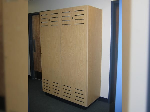 A large single tier wood lockers in a hallway.