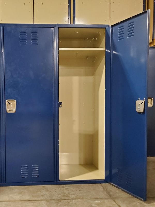 Used single-tier metal lockers with a blue outer finish and tan inner finish.