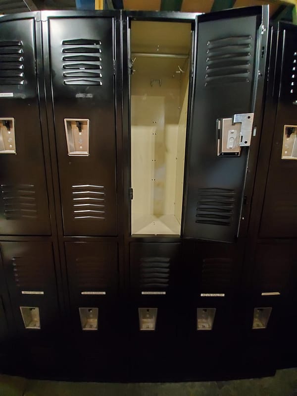 Used two-tier metal lockers with a black outer finish and tan inner finish.