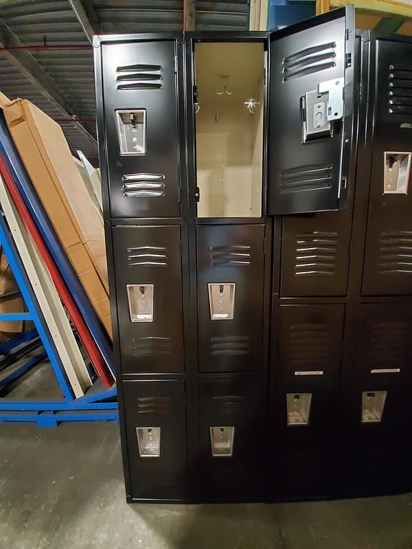 Used triple -tier metal lockers with a black outer finish and tan inner finish, with a door open.