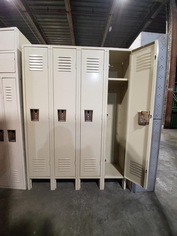 Used single-tier metal lockers with a tan finish and a door open.