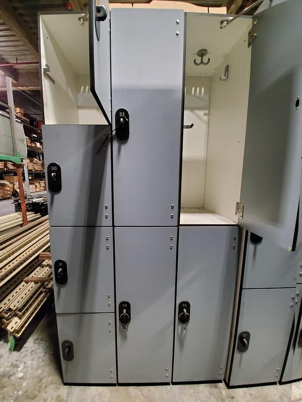 Used four and two-tier phenolic lockers with a gray finish, and doors open.