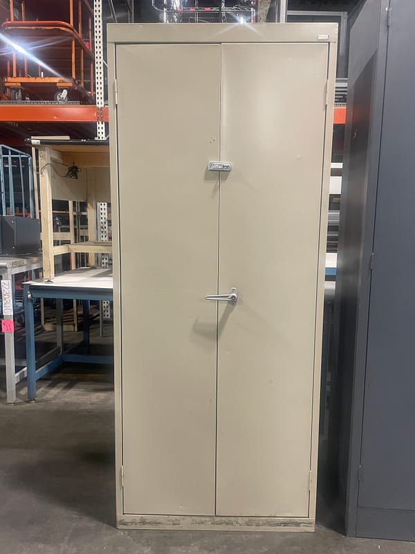 Tan used two door storage cabinet with one handle