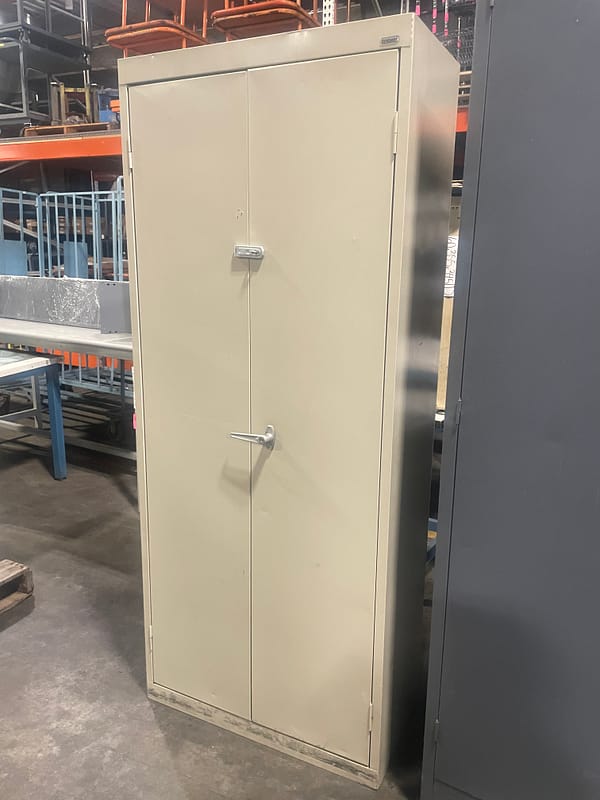 Tan used two door storage cabinet with one handle - side view