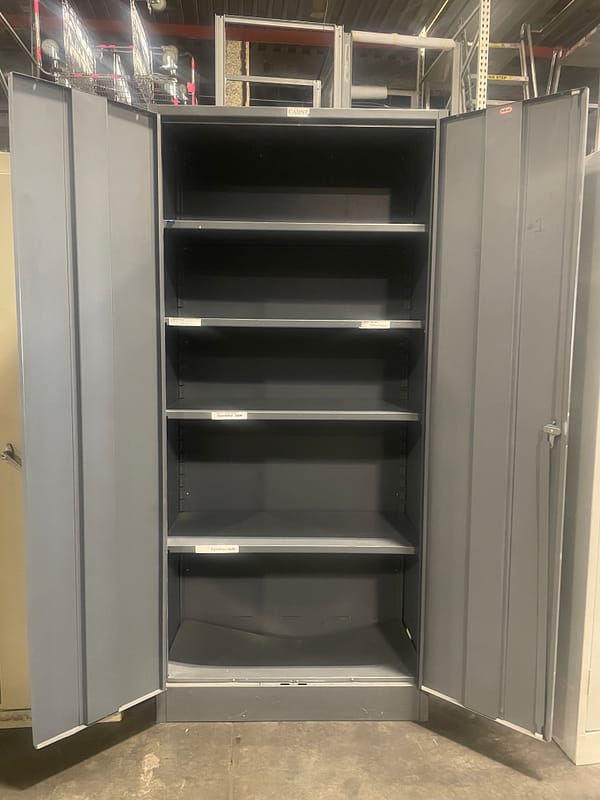 Gray used two door storage cabinet with the doors open, showing 4 shelves inside