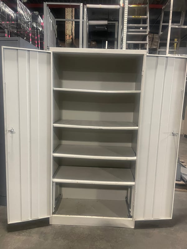 Inside used storage cabinet with 4 shelves