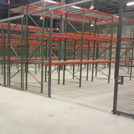 Pallet rack surrounded by a wire partition cage.